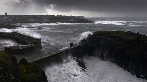 Waves crash against the harbour wall at Portstewart in Northern Ireland. (Getty)