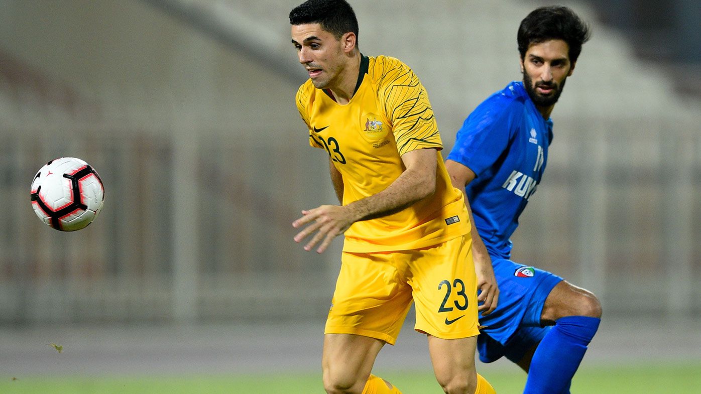 Tom Rogic fights for the ball during Australia's win over Kuwait