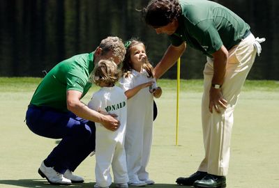 Phil Mickelson talks to the children of Luke Donald. (AAP)