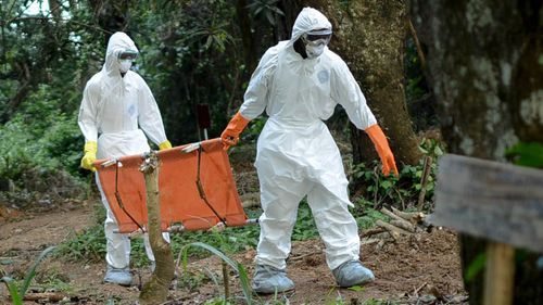 Members of a volunteer medical team wear special uniforms for the burial of 7 people, sterilized after dying due to the Ebola virus, in Kptema graveyard in Kenema, Sierra Leone on August 26, 2014. In recent months, Ebola a contagious disease for which there is no known treatment or cure has claimed at least 1429 lives in West Africa, mostly in Sierra Leone, Guinea and Liberia. (Photo by Mohammed Elshamy/Anadolu Agency/Gett Images)