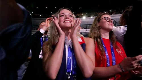 Supporters of former President Donald Trump cheer as he arrives on stage at a Turning Point Action gathering on Saturday.