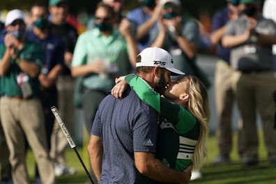 Dustin Johnson is hugged by Pauline Gretzky after winning the Masters golf tournament Sunday, Nov. 15, 2020, in Augusta, Ga. (AP Photo/David J. Phillip)