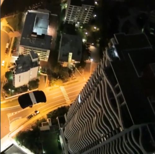 The man can be seen falling from the building before a parachute is released. Picture: Instagram.