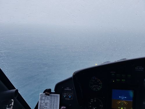 This photo was taken from the interior of the RACQ LifeFlight Rescue helicopter during a search for six men believed to be dead after their trawler sank off the central Queensland coast on Monday night. (AAP)