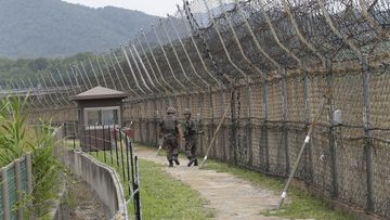 South Korean army soldiers patrol while hikers visit the DMZ Peace Trail in the demilitarized zone in Goseong, South Korea.