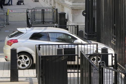 A car is stopped after colliding with the gates of Downing Street in London, Thursday, May 25, 2023. 