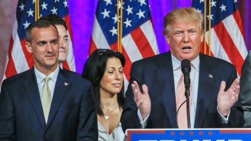 Donald Trump's campaign manager Corey Lewandowski listens as Trump speaks in Palm Beach, Florida on March 15, 2016. (AAP)