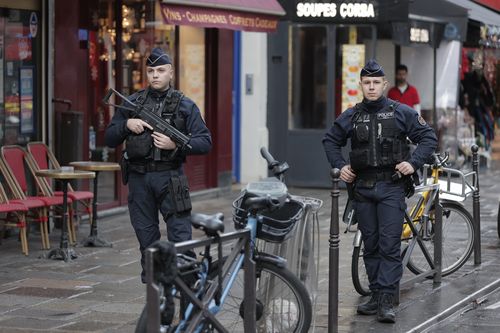 A police officers guards the crime scene where a shooting took place in Paris, Friday, Dec. 23, 2022.  