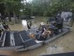Texas Parks &amp; Wildlife Department game wardens use a boat to rescue residents from floodwaters in Liberty County, Texas.
