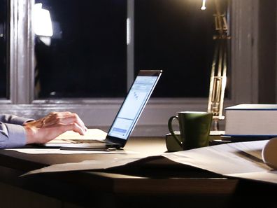 Man using computer in office at night