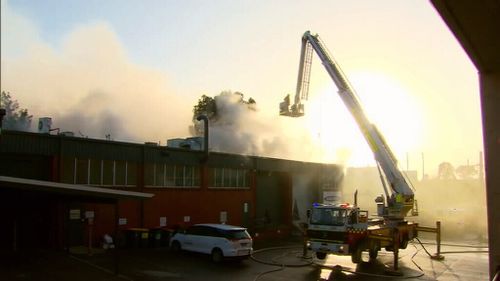 Thick smoke billowed from the building as it burned this morning. (9NEWS)