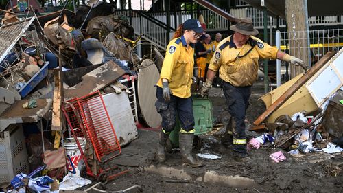 Volunteers from the local Rural Fire Brigade help to clean up a flood-affected primary school in Tumbulgum, Queensland.