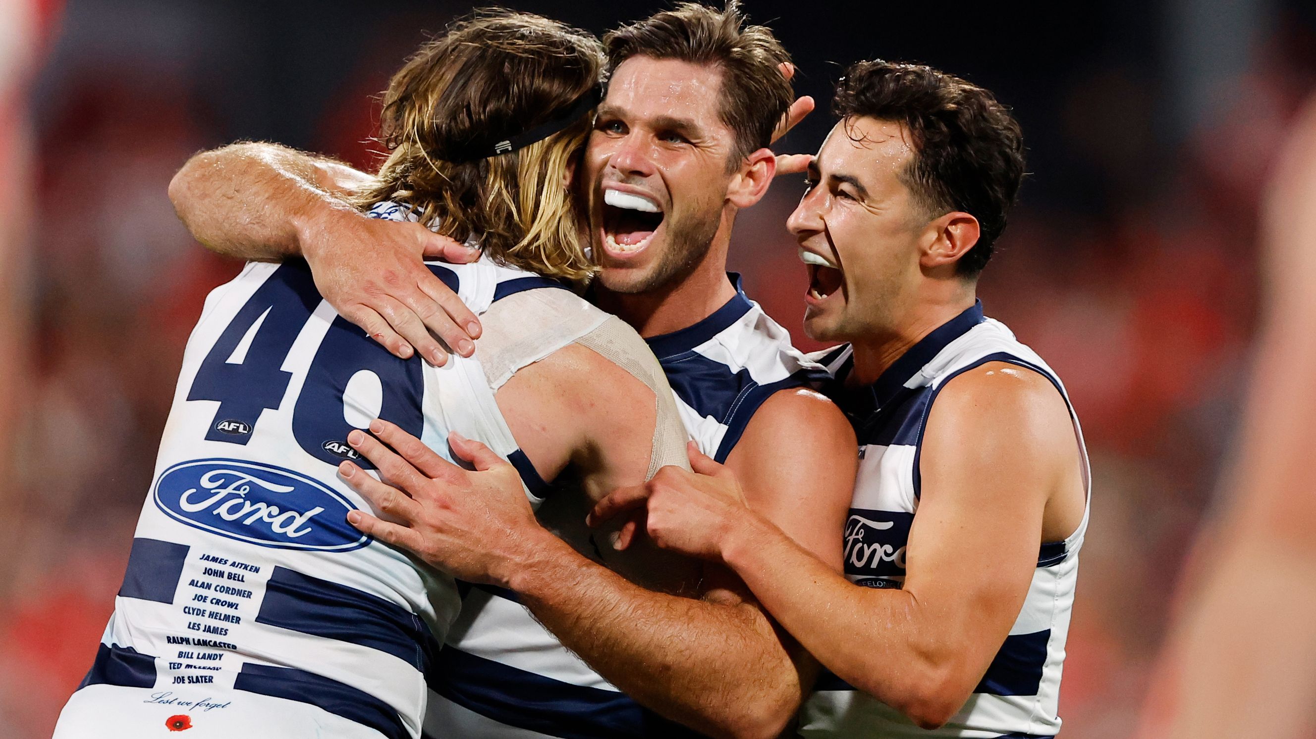 GEELONG, AUSTRALIA - APRIL 22: Tom Hawkins of the Cats celebrates a goal with teammates Mark Blicavs and Sam Simpson during the 2023 AFL Round 06 match between the Geelong Cats and the Sydney Swans at GMHBA Stadium on April 22, 2023 in Geelong, Australia. (Photo by Dylan Burns/AFL Photos)