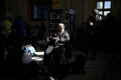 Ukrainian refugees wait at Przemysl train station, southeastern Poland, on Friday, March 11, 2022.