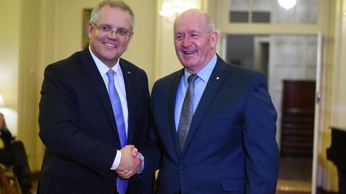 Australian Prime Minister Scott Morrison (left) shakes hands with Australian Governor-General Sir Peter Cosgrove during a swearing-in ceremony on Friday.
