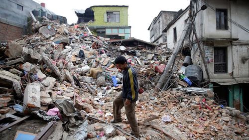 A man surveys the rubble of damaged building in Kathmandu. (AAP)