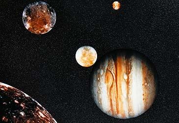 Who discovered the four largest of Jupiter's 67 known moons in 1610?