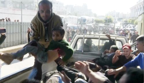 An injured child is unloaded from a vehicle at Nasser Hospital in Khan Younis after an Israeli airstrike on Saturday, November 30, 2024.