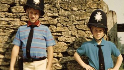 William and Harry pose in police hats, 1990s