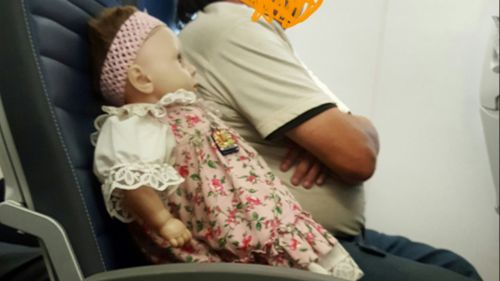 Plane passenger baffled after being seated beside doll with its own ticket