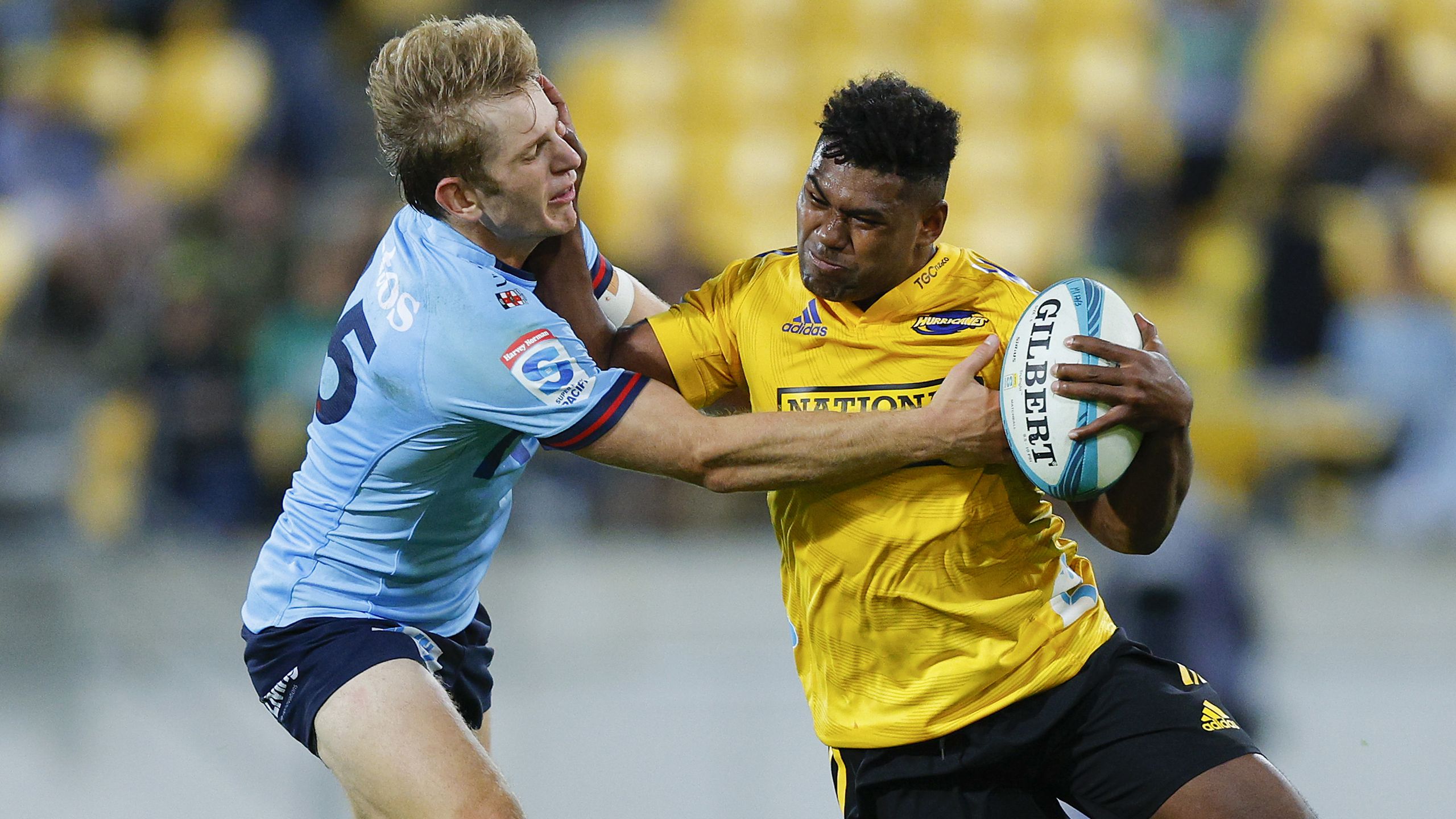 Kini Naholo of the Hurricanes is tackled by Max Jorgensen of the Waratahs.