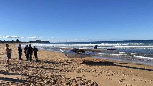 A light plane has landed on the sand at Collaroy Beach. 