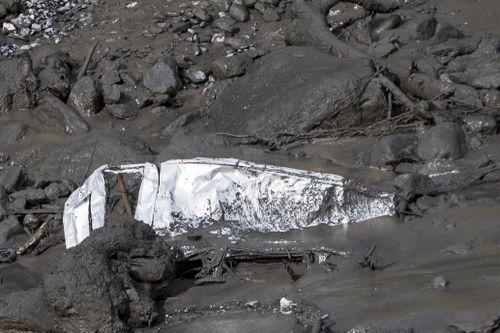 The wreckage of a car washed away by a mudslide resting in the bed of the Losentse River in Chamoson, canton Valais, Switzerland, 12 August 2019. 
