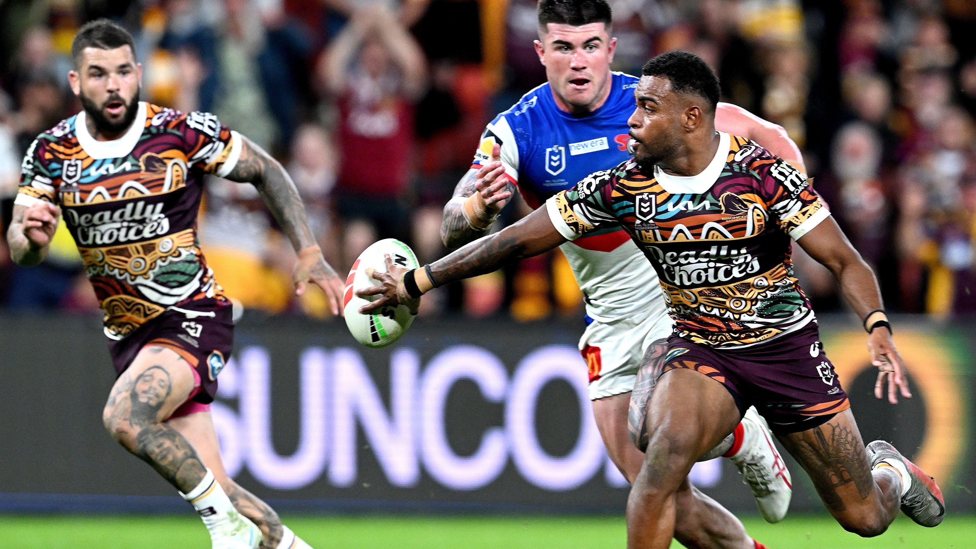 Ezra Mam flick passes the ball to Broncos teammate Adam Reynolds.