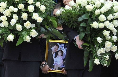 Dhakota pctured as a younh child with her father Carl Williams, at his funeral in 2010. (AAP)