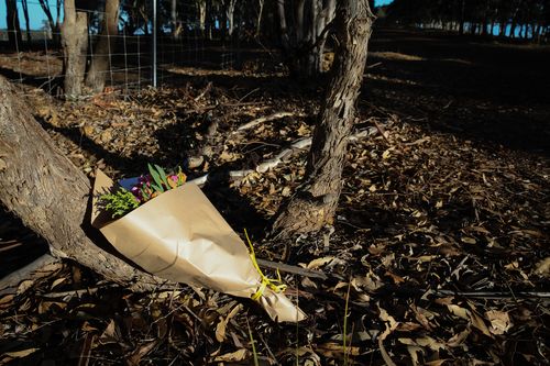 Flowers were left near the property for the family. 