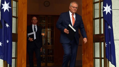 Prime Minister Scott Morrison arrives with Chief Medical Officer Paul Kelly to brief the media on today's National Cabinet meeting.