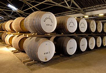 How long must Scotch be aged in oak barrels before being bottled?