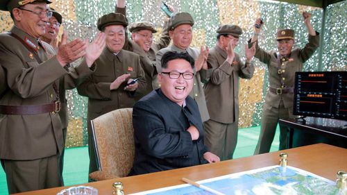 North Korea's top leader Kim Jong-un (seated) and military officials are elated after watching what the country claimed as a successful launch of its ballistic missile Hwasong-10. (AAP)