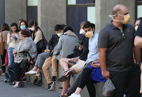 People line up outside the Royal Melbourne Hosital for coronavirus testing in Melbourne, Tuesday, March 10, 2020. 