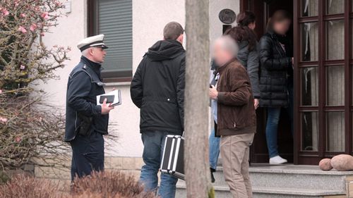 Police enter a house in Montabaur, Germany, believed to be that of Lubitz, to search for clues in the investigation. (AAP)
