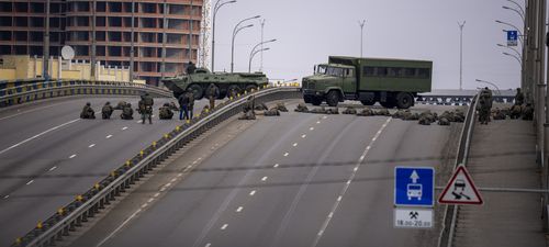 Ukrainian soldiers take position on a bridge inside the city of Kyiv, Ukraine, Friday, Feb. 25, 2022.