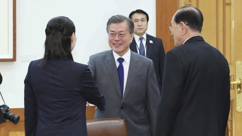 South Korean President Moon Jae-in, center, shakes hands with Kim Yo Jong, left, sister of North Korean leader Kim Jong Un (AAP)