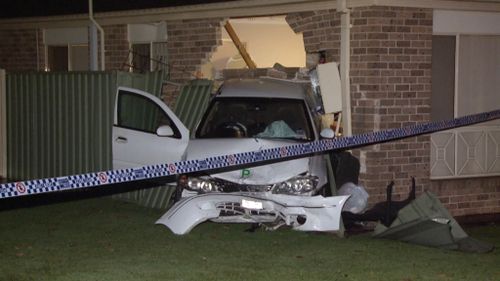A Green Valley woman has been taken to hospital after a car slammed into her home. (9NEWS)