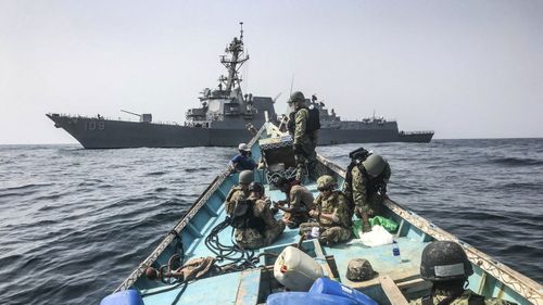 Search and seizure team from the guided-missile destroyer USS Jason Dunham (DDG 109) inspects a dhow while conducting maritime security operations. (AP)