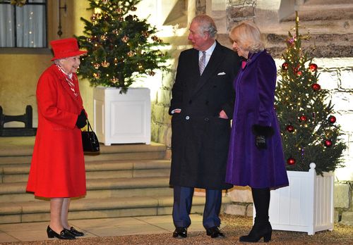 Queen Elizabeth (left) talks with Prince Charles, Prince of Wales (centre) and Camilla, Duchess of Cornwall (right) in the quadrangle of Windsor Castle on December 8, 2020 in Windsor, England.