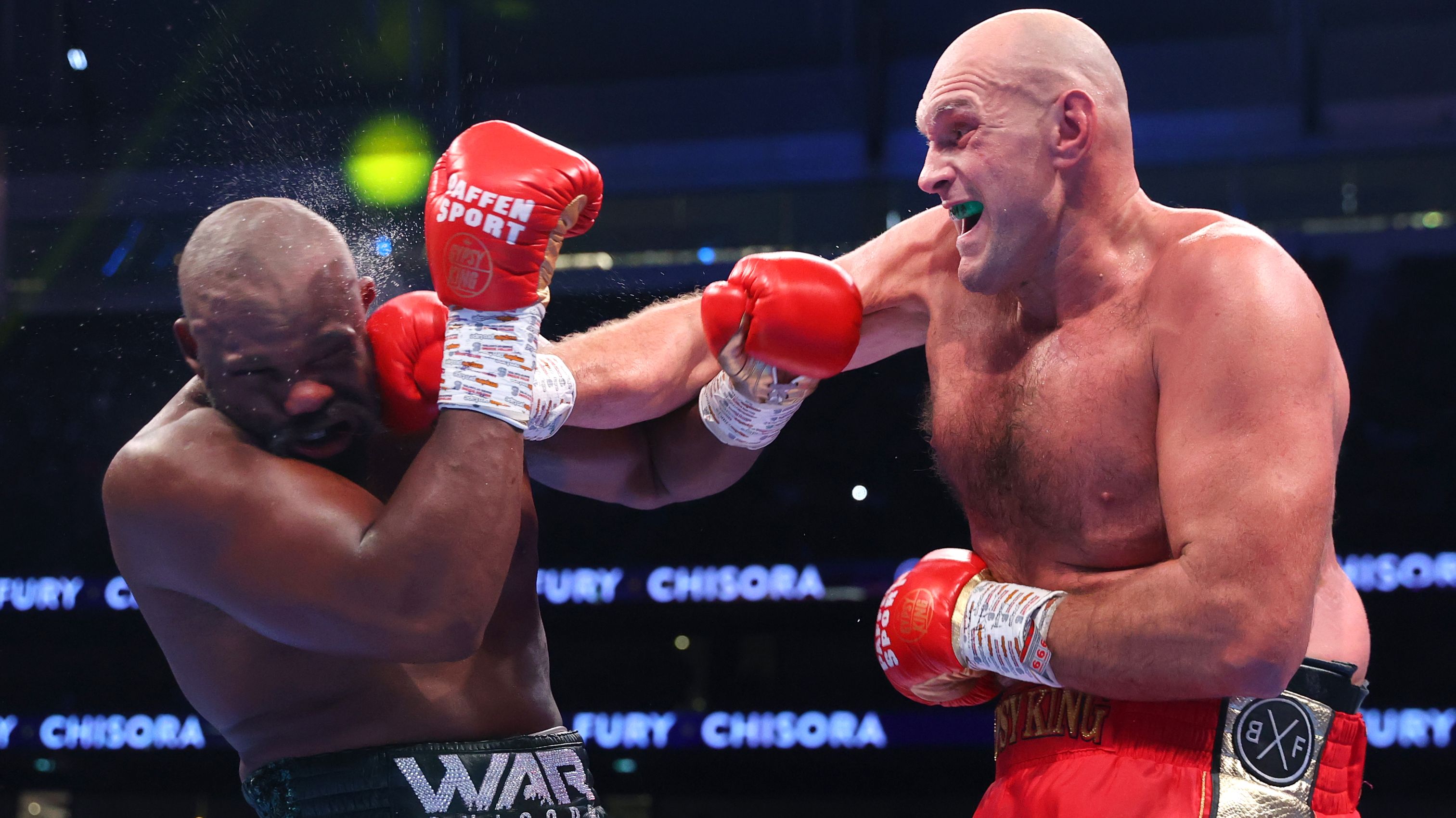 Derek Chisora is punched by Tyson Fury during their WBC heavyweight championship fight, at Tottenham Hotspur Stadium. (Photo by Mikey Williams/Top Rank Inc via Getty Images)