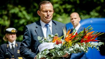 Prime Minister Tony Abbott has laid a wreath to victims of flight MH17 and revealed that the Australians who died will initially be flown to Melbourne. (AAP)