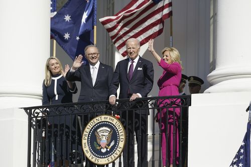 President Joe Biden, first lady Jill Biden, along with Australia's Prime Minister Anthony Albanese and his partner Jodie Haydon, look on and wave from the Blue Room Balcony during a State Arrival Ceremony on the South Lawn of the White House, Wednesday, Oct. 25, 2023, in Washington.