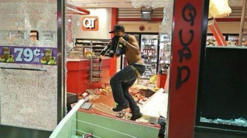 A looter breaks into a store in Ferguson, Missouri. (Twitter/@IDAF134)