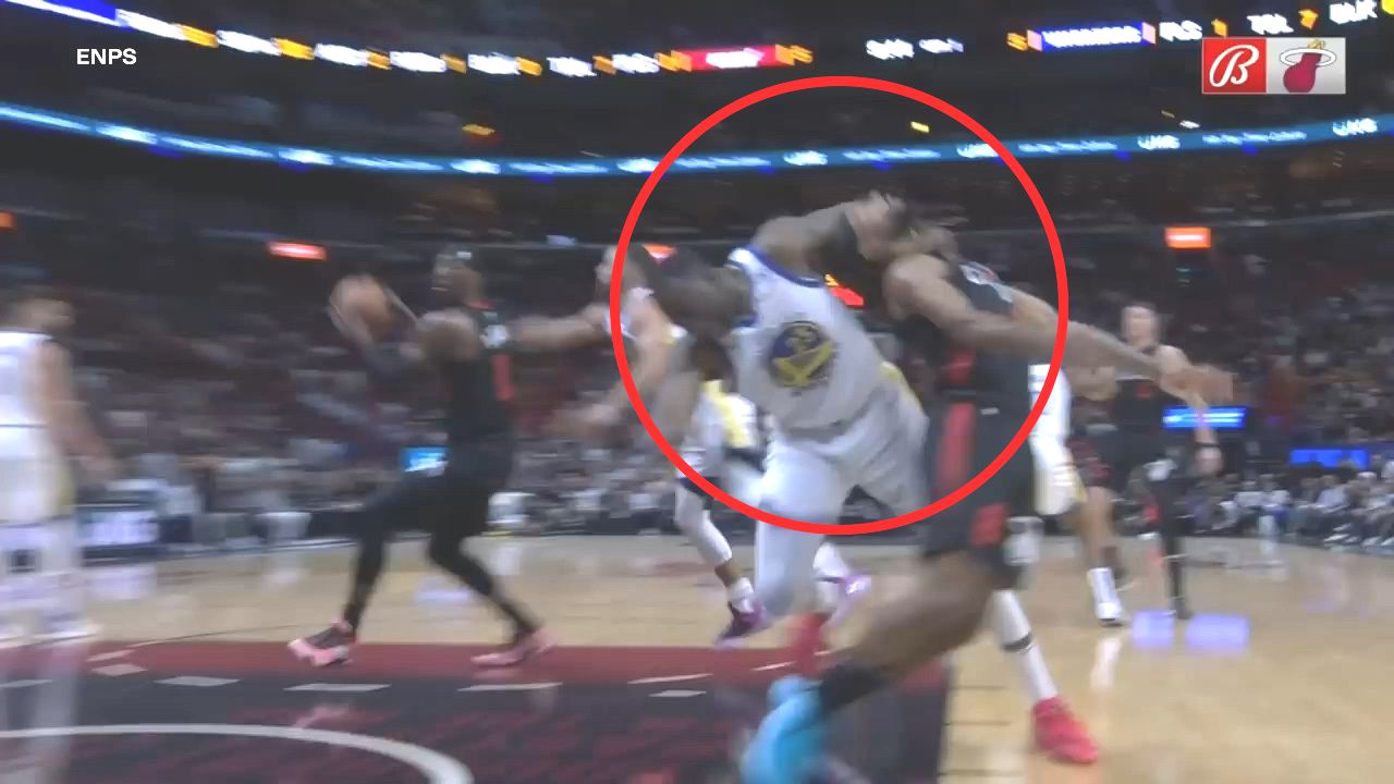 Draymond Green drags Patty Mills (right) by the neck.