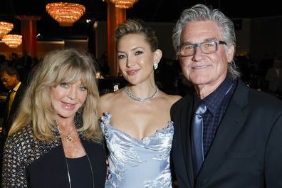 BEVERLY HILLS, CALIFORNIA - OCTOBER 08: (L-R) Goldie Hawn, Kate Hudson and Kurt Russell attend Will Rogers Motion Picture Pioneers Foundation's Pioneer Dinner honoring Kate Hudson at The Beverly Hilton on October 08, 2025 in Beverly Hills, California.  (Photo by Frazer Harrison/Getty Images)