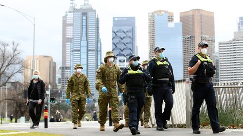 Police and the Australian military patrol the banks of the Yarra River in Melbourne, Australia. Face masks or face coverings are now mandatory for anyone leaving their homes in the Melbourne metropolitan area or the Mitchell Shire.