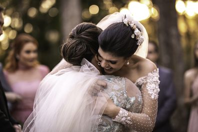 Guest hugging bride