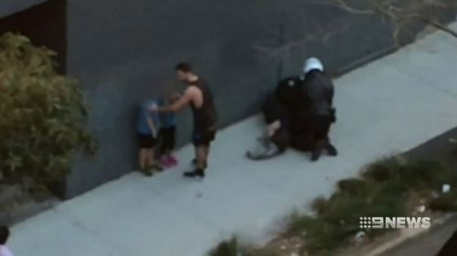 Mr Burdett being wrestled to the ground by police. (9NEWS)
