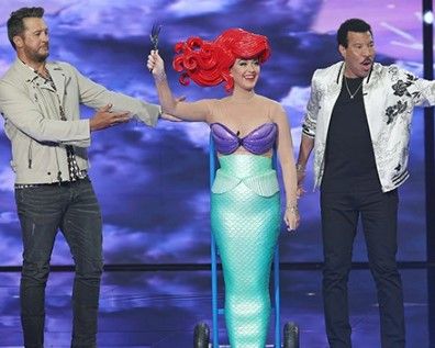 Katy Perry falls off her chair while dressed as the Little Mermaid on American Idol 
